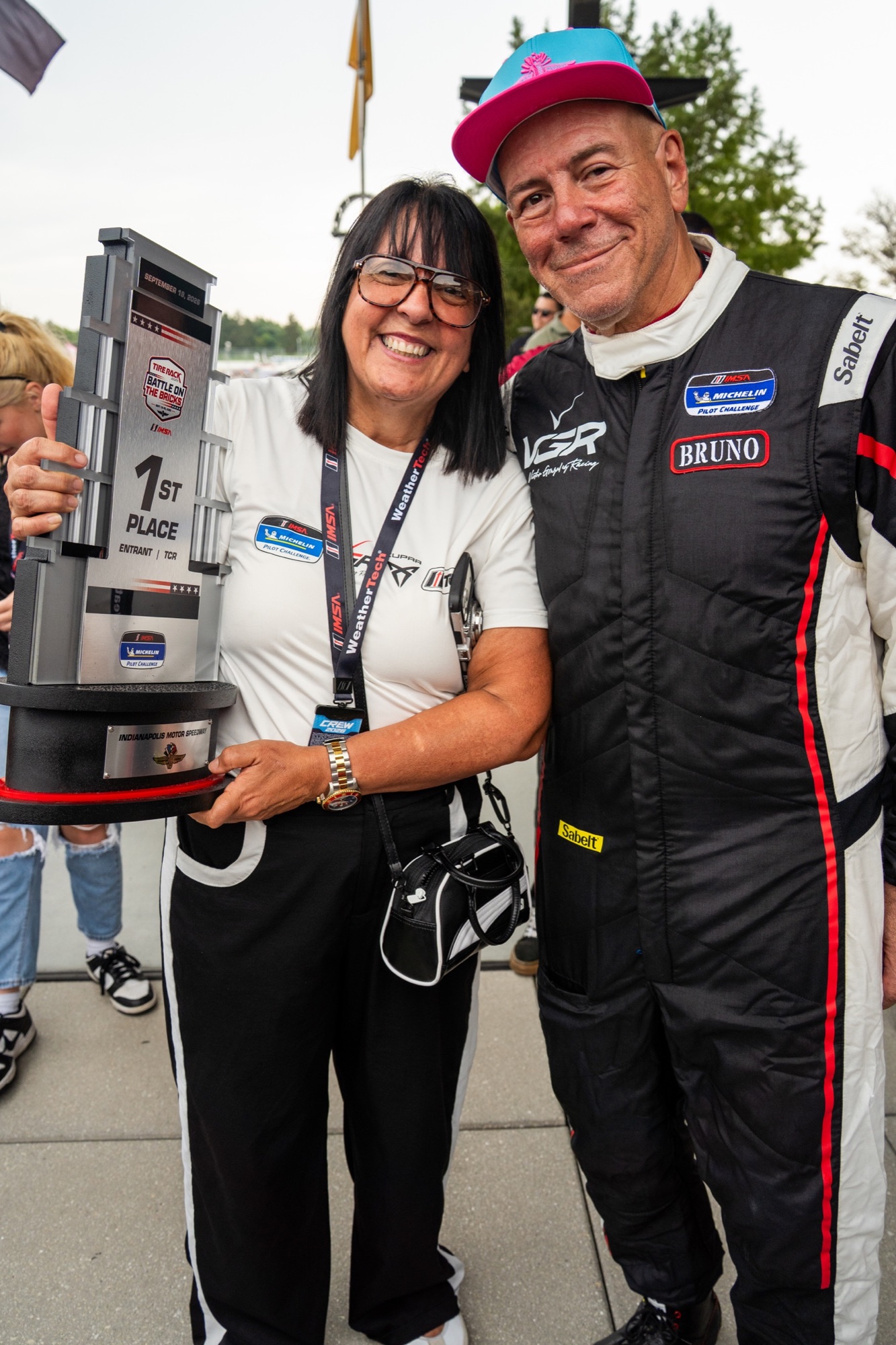Marisol Toledo and Héctor Bruno celebrate with the Indianapolis TCR winner trophy